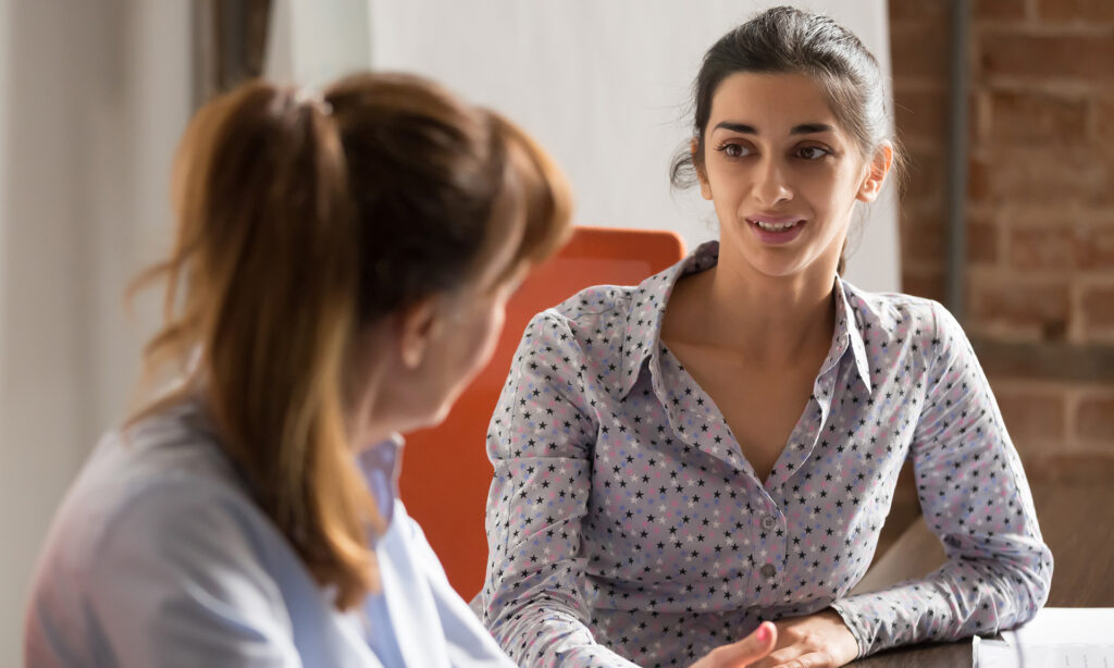 businesswoman speaking to colleague during job interview