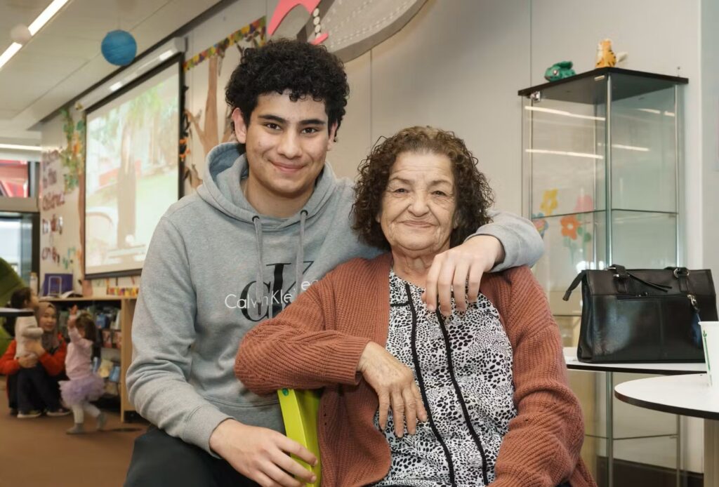 A young carer with his elderly mother in a Library