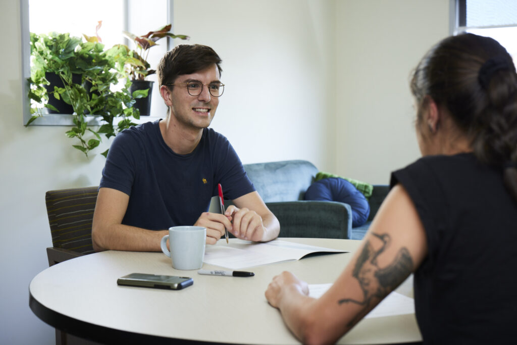 A woman and a man sitting at a table during a consultaion