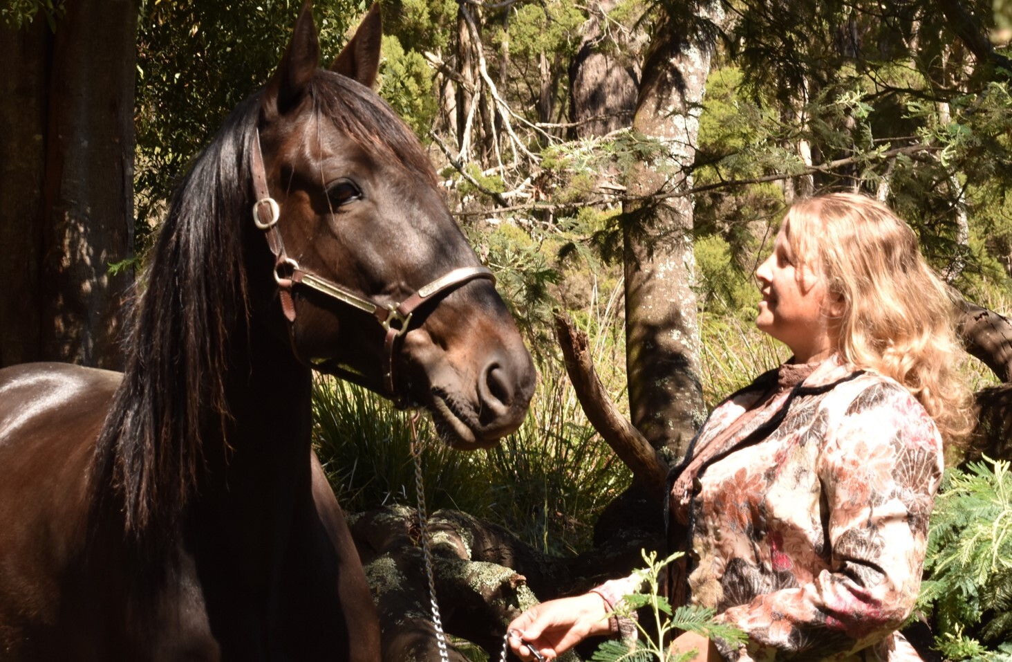 Clare long smiling and looking at her horse