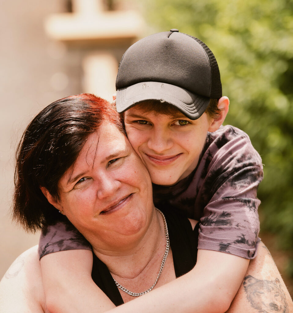 A mother and her son hugging and smiling