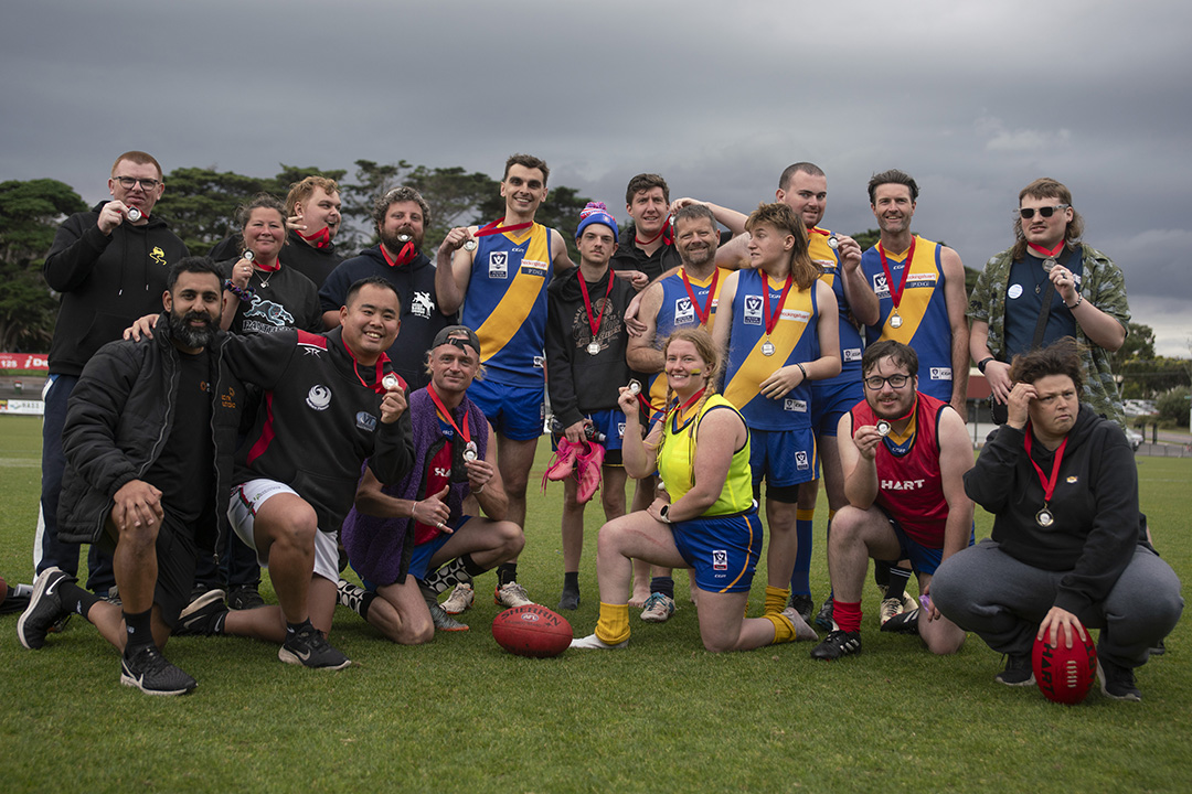 A football team on the field posing for a photo